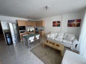 a living room with a white couch and a table at Casa Eva in Los Llanos de Aridane