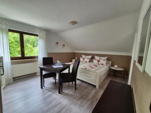 a room with a bed and a table and chairs at Haus Grünewald in Zell an der Mosel