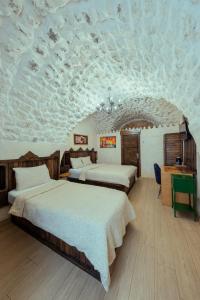 a bedroom with two beds and a ceiling covered in clouds at Narlı Ev Butik Otel in Urfa +58 photos