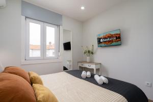 a bedroom with a bed with two white towels on it at Charming Bright House w/ Garden by HostWise in Porto