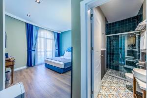 a small bathroom with a bed and a shower at Nenessa Airport Hotel in Arnavutköy +62 photos