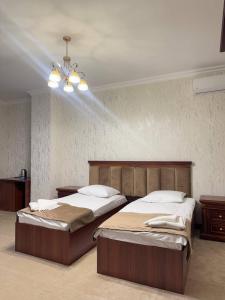 a bedroom with two beds and a chandelier at Golden Kapan in Kapan +31 photos