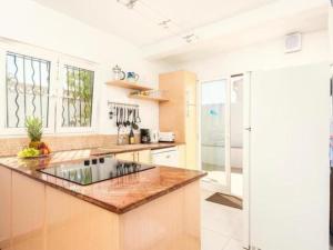 a kitchen with a counter top and a refrigerator at Villa Valeria in Cala'n Porter