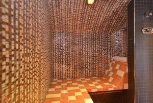 a bathroom with a tiled shower with a toilet at Hôtel Les Chalets de Philippe avec Jacuzzis Privatifs in Chamonix +57 photos
