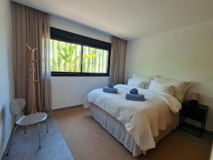 a bedroom with a large bed and a window at Villa Benimaurell Relax Beach Moraira in Moraira +36 photos