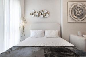 a white bed in a room with a window at شقة استوديو فاخرة في الزاهية الشارقة - cozy Studio in Sharjah +19 photos