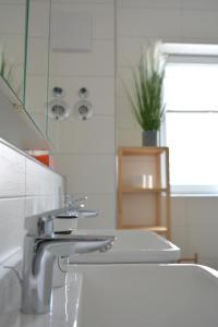 a bathroom with a sink and a mirror at Schwarzwald Lahr Europapark Penthouse Sunshine in Lahr +44 photos
