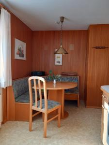 a dining room with a table and a couch at Large house with large garden in Lauterach +8 photos