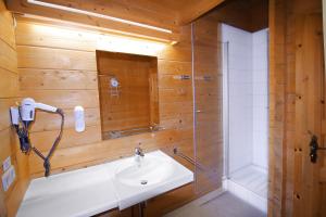 a bathroom with a sink and a shower at Ferienhaus Donau 31 Glückskäfer in Hayingen +6 photos