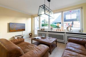 a living room with a couch and a table at Meeresstern in Westerland (Sylt)