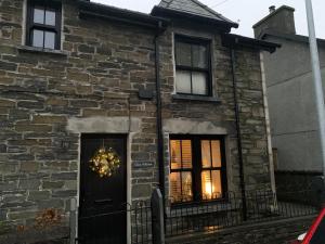 a brick house with a christmas wreath on the door at Glan William in Dolwyddelan