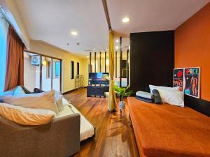 a living room with two couches and a television at Sunway Resort Suite #29 1- 6paxs Sunway Lagoon Pyramid in Petaling Jaya