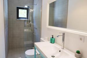 a bathroom with a sink and a toilet and a shower at PH in Aroeira Lisbon - Beach & Golf in Aroeira +29 photos