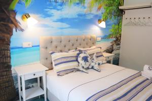 a bedroom with a bed with a beach mural at PH in Aroeira Lisbon - Beach & Golf in Aroeira