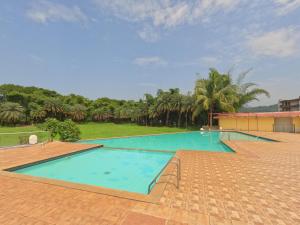 卡尔贾特Ivy Bliss Studio with Private Pool, B 06, Karjat的棕榈树度假村内的大型游泳池