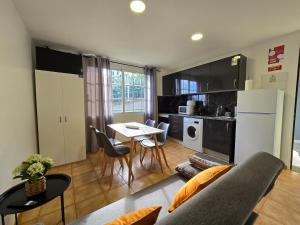 a kitchen and living room with a couch and a table at Autonomia House II in Câmara de Lobos