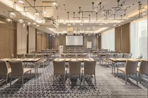 a conference room with tables and chairs and a projection screen at InterContinental Taichung by IHG in Taichung +37 photos