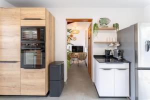 a kitchen with a refrigerator and a counter top at Villa Opale in Terre-de-Haut