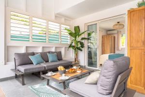 a living room with a couch and a table at Villa Opale in Terre-de-Haut