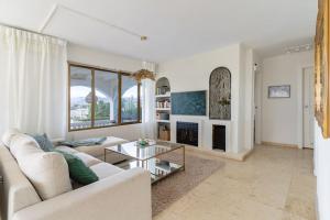 a living room with a couch and a fireplace at Exclusive Villa Marbella in Marbella