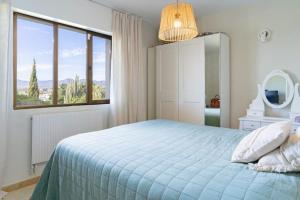a bedroom with a bed and a large window at Exclusive Villa Marbella in Marbella