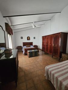 a bedroom with two beds and a table in it at Vivienda Turistica de Alojamiento Rural El Jaral in Alcaracejos +17 photos
