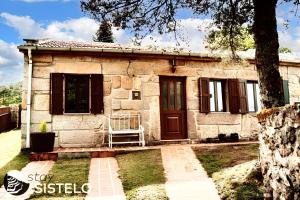 a small stone house with a red door at Charming House in Sistelo + View in Sistelo