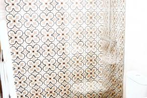 a shower curtain with a floral pattern on it at Charming House in Sistelo + View in Sistelo +4 photos