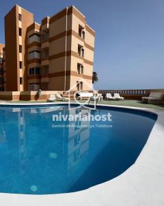 a swimming pool in front of a building at Sunrise Radazul, by Nivariahost in Radazul