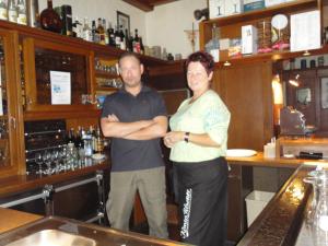 a man and a woman standing in a bar at Hotel-Restaurant-Schlosskrug in Saarbrücken