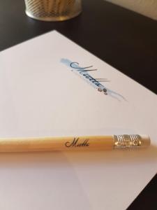 a wooden pen sitting on top of a piece of paper at Villaggio Mietta in Castiglioncello