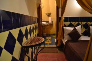 Postel nebo postele na pokoji v ubytování Riad Hôtel Belleville Marrakech