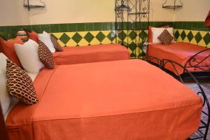 Postel nebo postele na pokoji v ubytování Riad Hôtel Belleville Marrakech