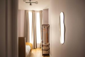 a bedroom with a bed and a large window at Bob W London Holland Park in London