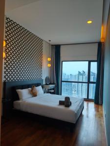 a bedroom with a large bed and a large window at Reizz Residence Majesty Suite in Kuala Lumpur
