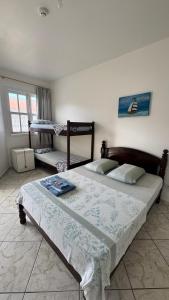 a bedroom with a bed in a room with a window at Hotel Nils in Itapoa