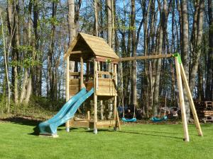 a playground with a slide and a play tower at Séjour en famille au Bois Joli, détente, nature, activités pour tous in Beauraing