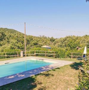 a swimming pool in the yard of a house at Camping Lucherino in Monticello