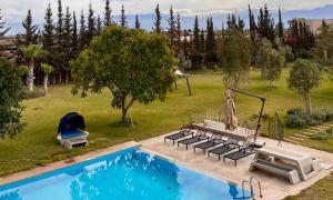 an overhead view of a swimming pool with chairs and a swing at Hala Luxury Domain in Marrakech