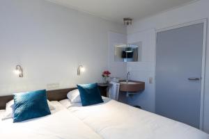 Postel nebo postele na pokoji v ubytování Hotel de Magneet
