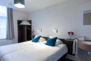 Postel nebo postele na pokoji v ubytování Hotel de Magneet