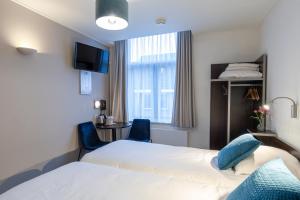 Postel nebo postele na pokoji v ubytování Hotel de Magneet