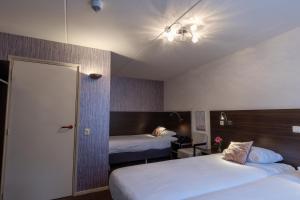 Postel nebo postele na pokoji v ubytování Hotel de Magneet