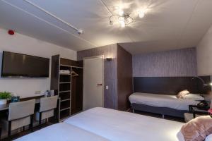 Postel nebo postele na pokoji v ubytování Hotel de Magneet