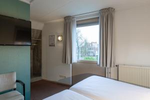 Postel nebo postele na pokoji v ubytování Hotel de Magneet