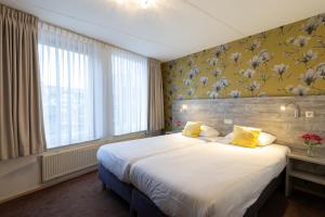Postel nebo postele na pokoji v ubytování Hotel de Magneet