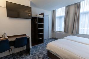 Postel nebo postele na pokoji v ubytování Hotel de Magneet