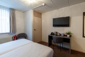 TV a/nebo společenská místnost v ubytování Hotel de Magneet
