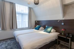 Postel nebo postele na pokoji v ubytování Hotel de Magneet