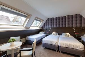 Postel nebo postele na pokoji v ubytování Hotel de Magneet